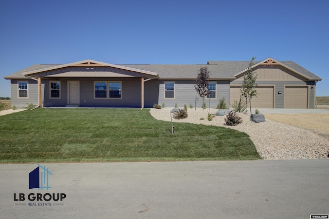 ranch-style house featuring a garage and a front lawn