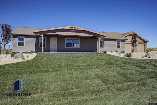 ranch-style home featuring a garage and a front yard