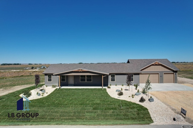 ranch-style house with a garage and a front lawn