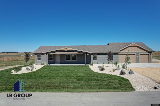 single story home featuring a garage and a front lawn