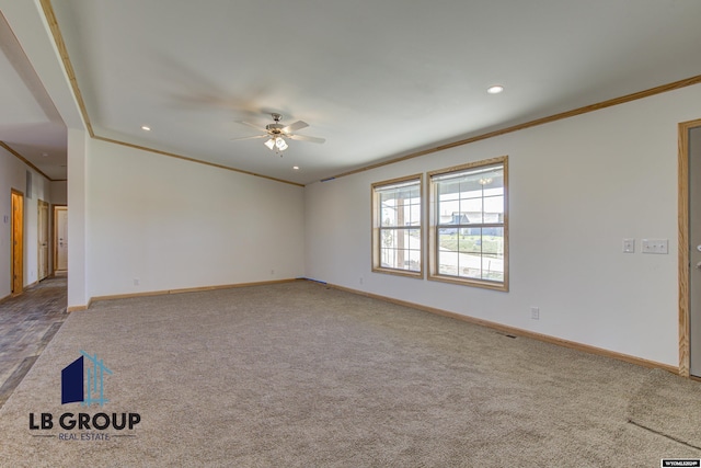 spare room featuring ceiling fan, ornamental molding, and carpet flooring