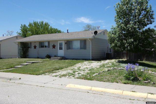 view of front facade with central AC unit and a front yard