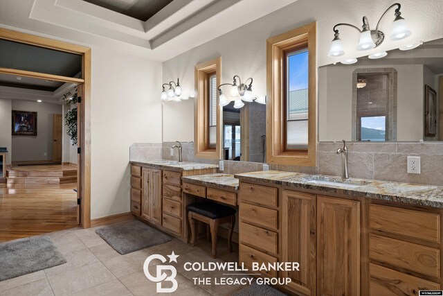 bathroom featuring vanity, a raised ceiling, and tile patterned flooring