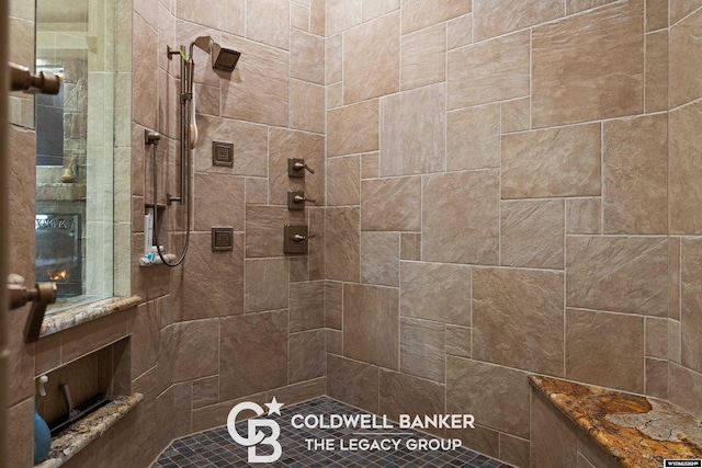 bathroom with tiled shower