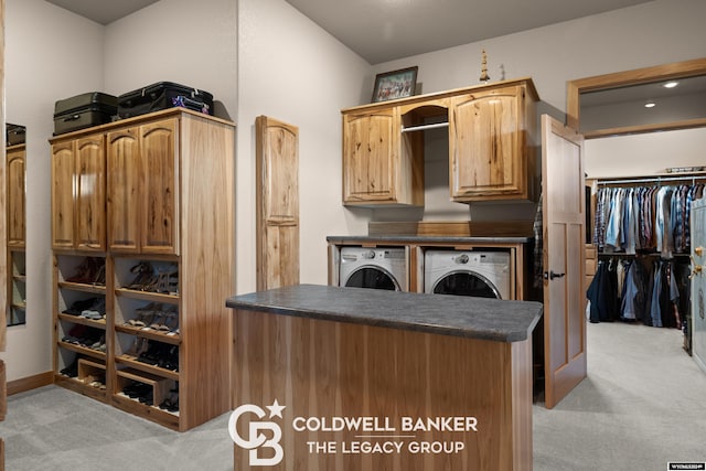 walk in closet featuring light carpet and washer and clothes dryer