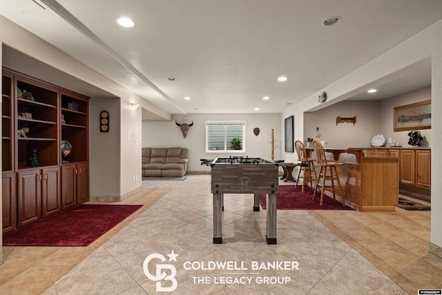 playroom featuring bar and light tile patterned floors