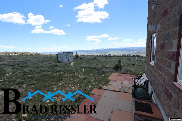 view of terrace featuring a mountain view and a rural view