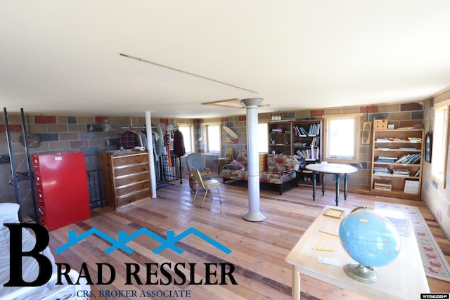 interior space with a wealth of natural light and hardwood / wood-style flooring