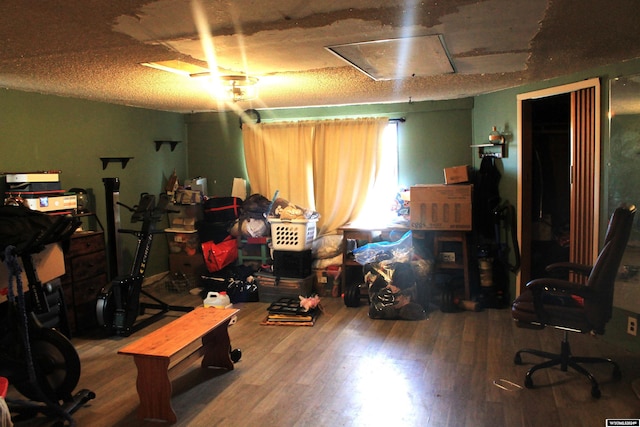 interior space featuring hardwood / wood-style flooring and a textured ceiling