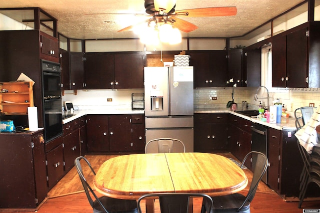 kitchen with ceiling fan, tasteful backsplash, wood-type flooring, white fridge with ice dispenser, and a textured ceiling