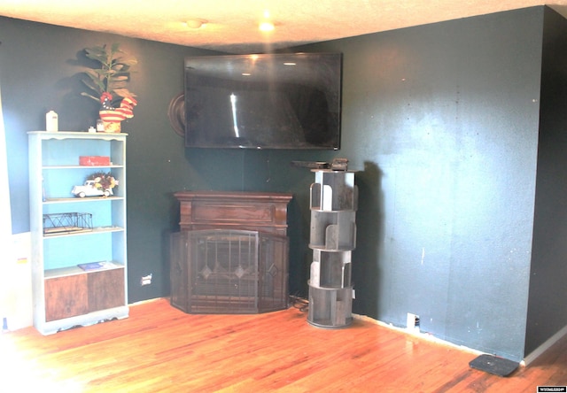 living room with built in features and hardwood / wood-style floors