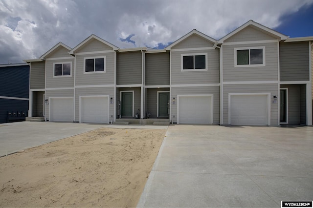 view of property with a garage and driveway