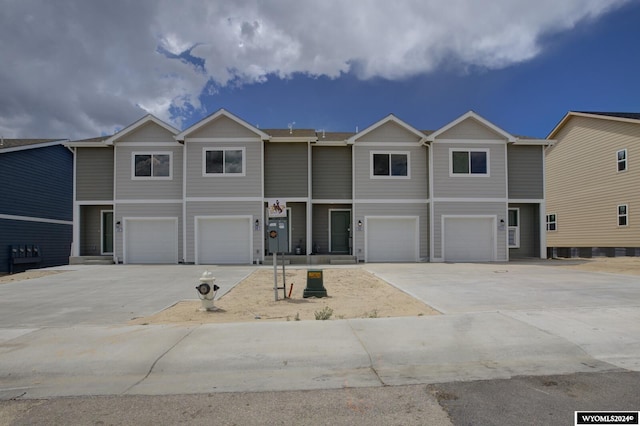 multi unit property featuring driveway and a garage