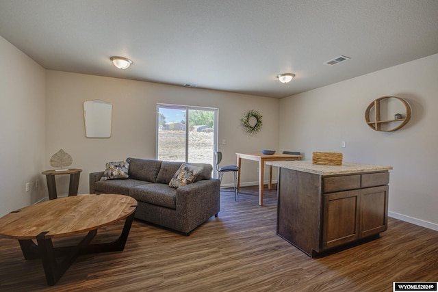 living area featuring dark wood-style floors, baseboards, and visible vents