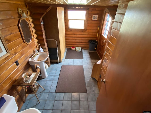 interior space featuring tile flooring and log walls