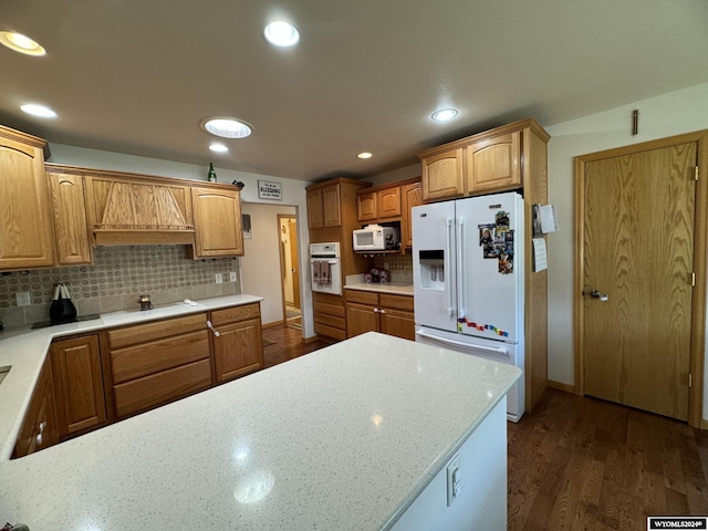 kitchen featuring decorative backsplash, dark hardwood / wood-style flooring, white appliances, and custom exhaust hood