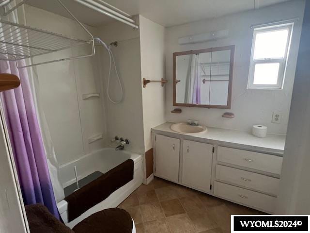 full bathroom with shower / bath combination with curtain, vanity, and toilet