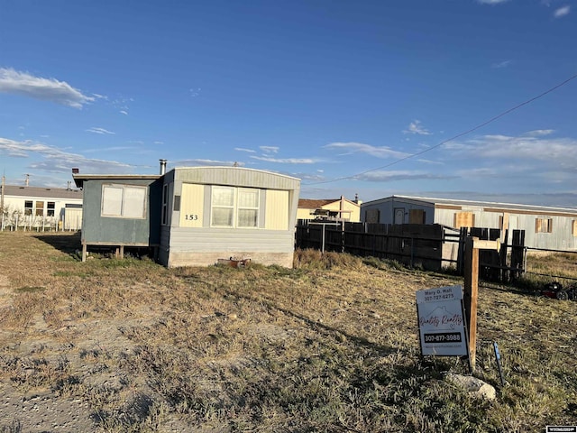153 Bobcat St, Opal, WY 83124 - view of side of property with fence and an outbuilding
