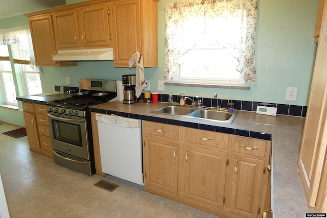 160 Pleasant Valley Rd, Hartville, WY 82215 - kitchen featuring white dishwasher, sink, tile counters, and stainless steel range with gas stovetop