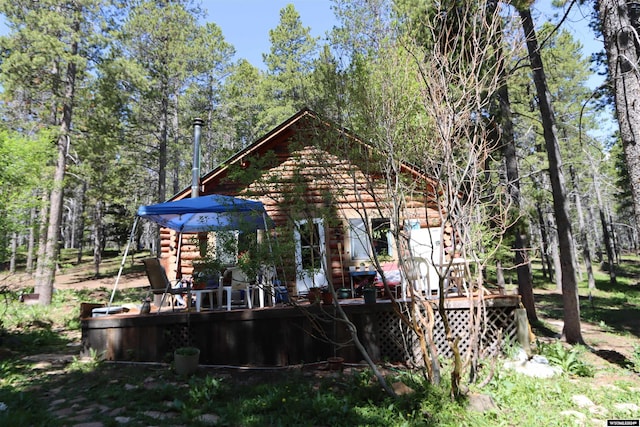 rear view of house with a wooden deck