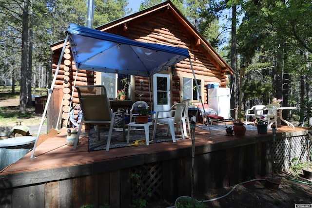 back of property with a wooden deck