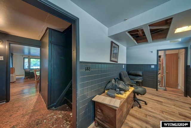 office area with tile walls and hardwood / wood-style flooring