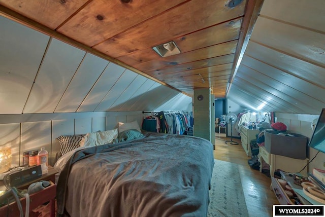 bedroom featuring wood-type flooring, vaulted ceiling, and wood ceiling