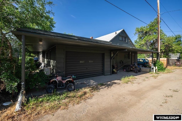 view of home's exterior with a carport and a garage