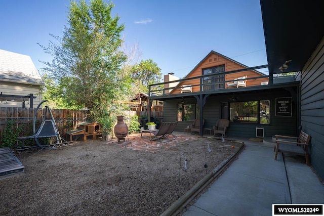 view of yard with a balcony and a patio