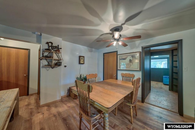 dining space featuring ceiling fan and hardwood / wood-style flooring