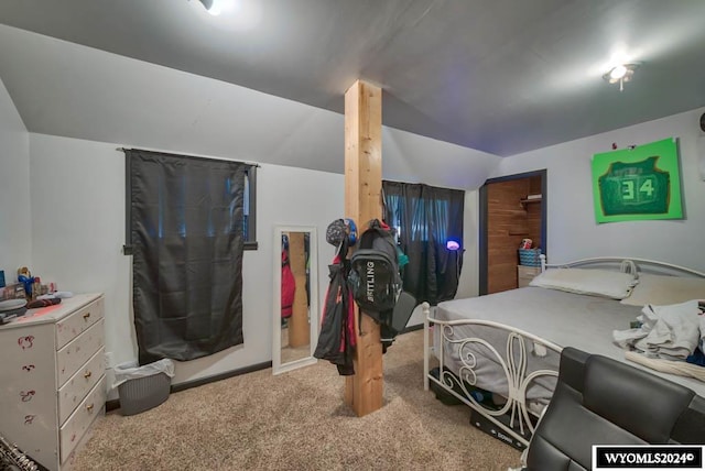 carpeted bedroom featuring lofted ceiling