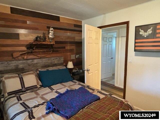 bedroom featuring wooden walls