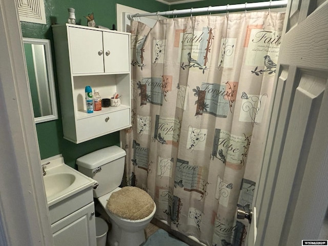 bathroom with vanity, toilet, and walk in shower