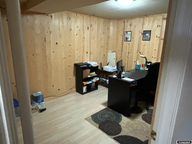 home office featuring wood walls and hardwood / wood-style floors