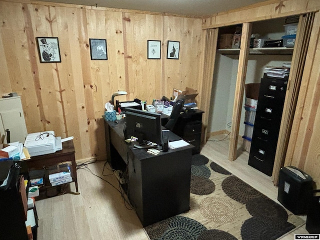 home office featuring wooden walls and light wood-type flooring