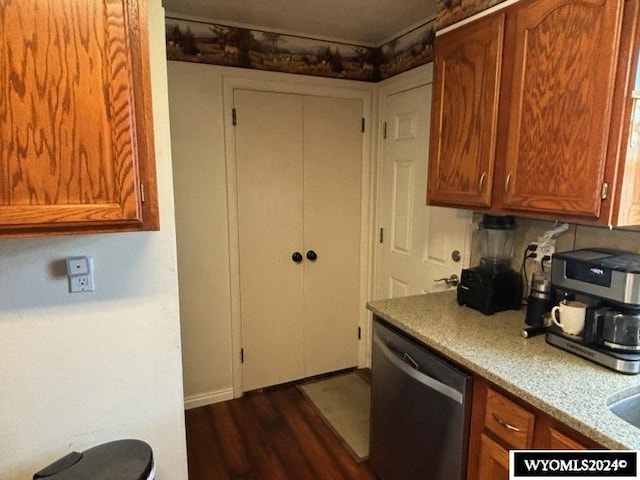 kitchen featuring stainless steel dishwasher and dark wood-type flooring