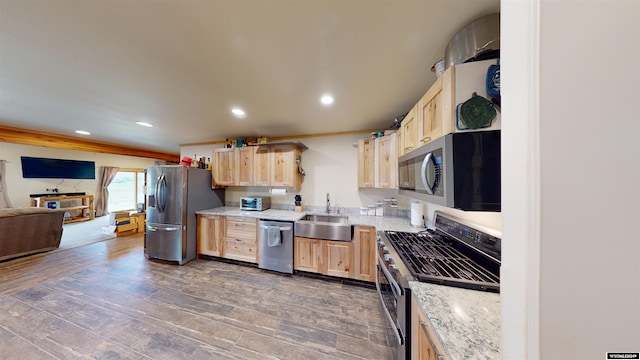 kitchen featuring dark wood-type flooring, sink, appliances with stainless steel finishes, and light brown cabinetry