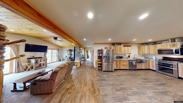 kitchen featuring lofted ceiling with beams, stainless steel appliances, dark hardwood / wood-style flooring, light brown cabinetry, and ceiling fan