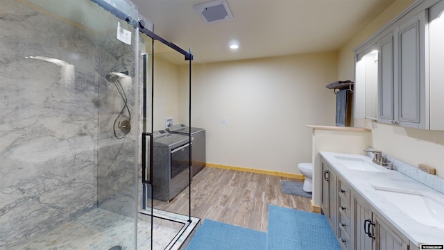 bathroom featuring a shower with door, wood-type flooring, and toilet