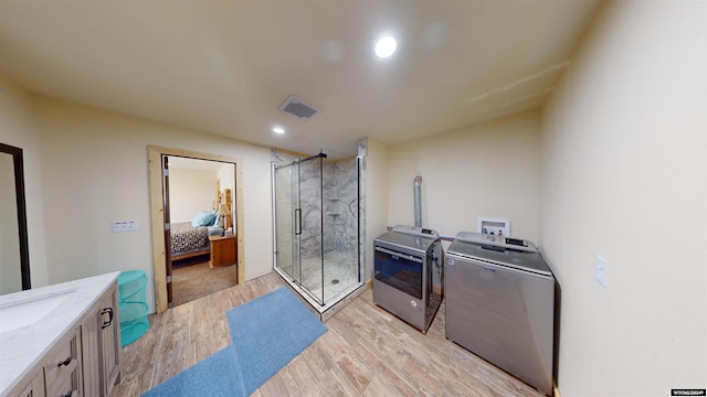 washroom featuring washer and dryer and light hardwood / wood-style floors