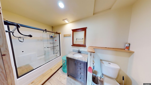 full bathroom featuring tile patterned flooring, toilet, shower / bath combination with glass door, and vanity