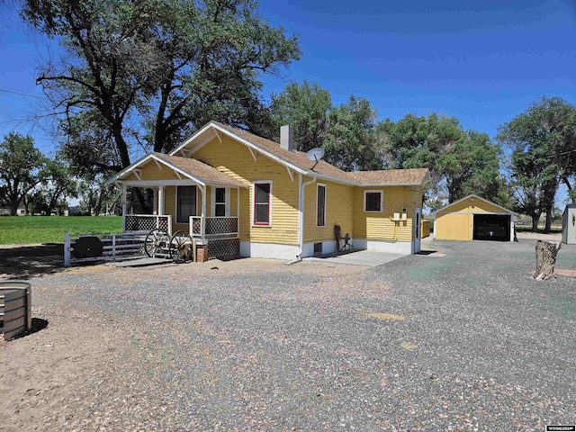 view of front of property featuring an outbuilding, a porch, and a garage