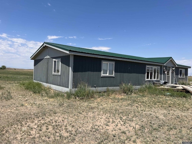 view of side of property featuring metal roof