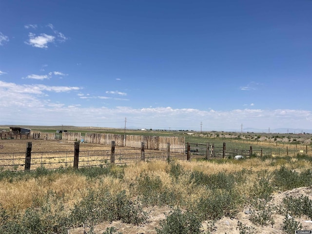 view of yard featuring a rural view and fence