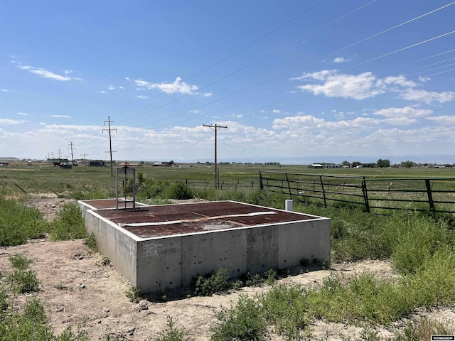 view of yard featuring fence and a rural view