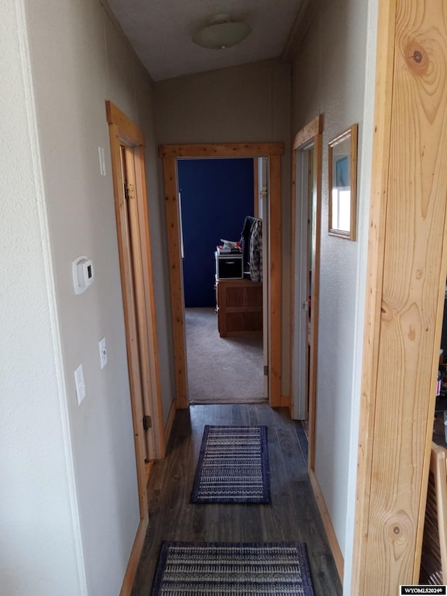 hallway with dark wood-style floors and baseboards