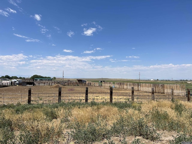 view of yard with a rural view and fence