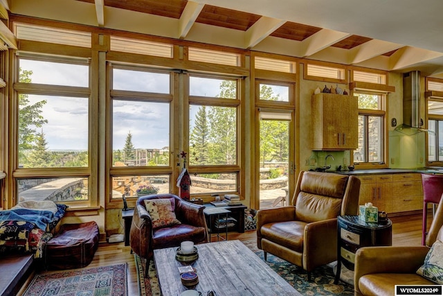 sunroom with plenty of natural light and beam ceiling