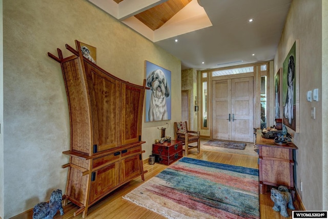 foyer entrance featuring light hardwood / wood-style flooring and vaulted ceiling