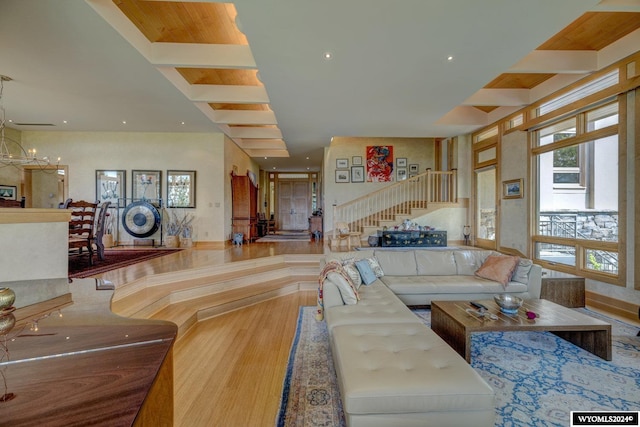 living room with an inviting chandelier and beam ceiling